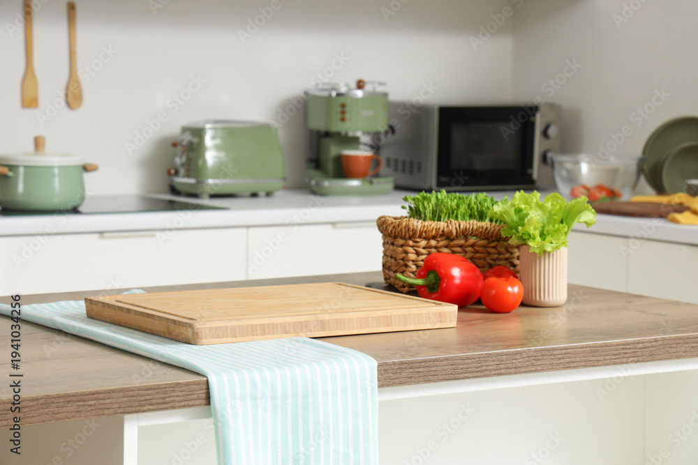 Fototapeta premium Cutting board with vegetables on table in kitchen