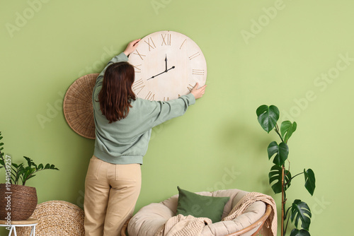 Young woman hanging big clo...