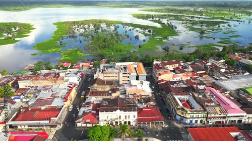 High-resolution aerial view of the riverfront boulevard in Iquitos featuring colorful historic buildings, vibrant urban streets, and a scenic promenade along the majestic Amazon River
