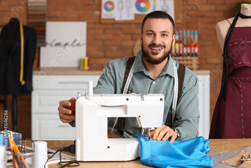 Male tailor sewing clothes ...
