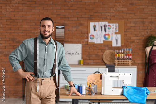 Male tailor with sewing mac...