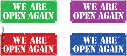 Four colorful signs with the message 'We are open again' on a white background