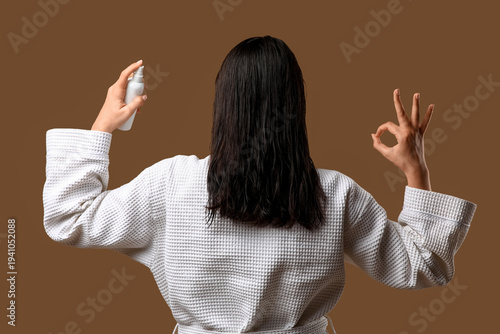 Young woman with hair spray...
