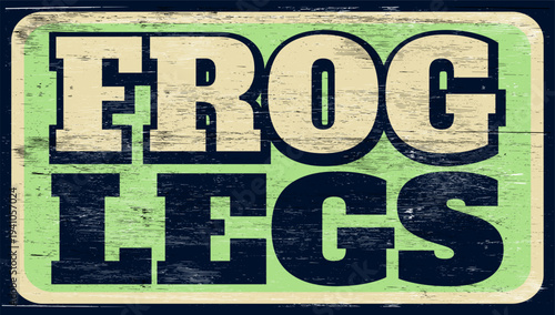 Aged and worn frog legs sign on wood