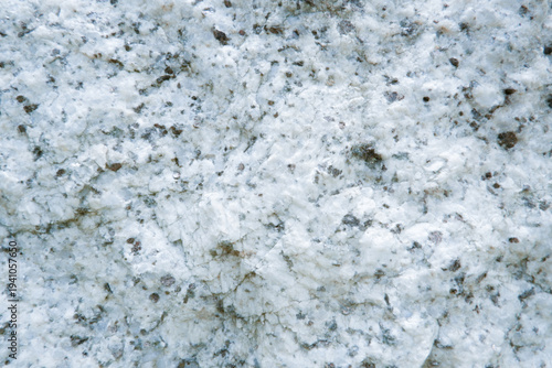 Close up of granite surface texture. Intrusive igneous rock