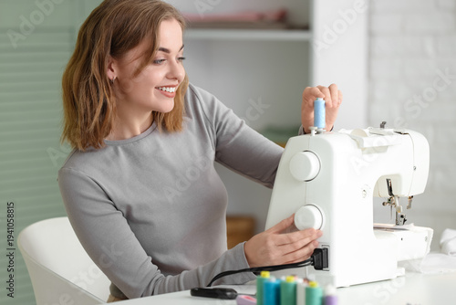 Female tailor using sewing ...