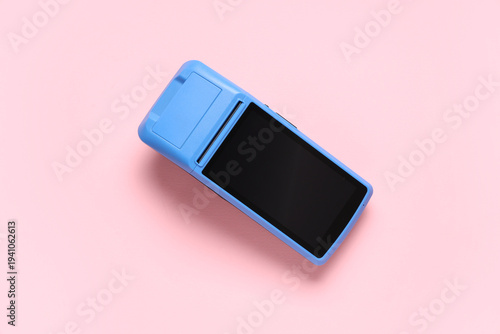 Payment terminal on pink ba...