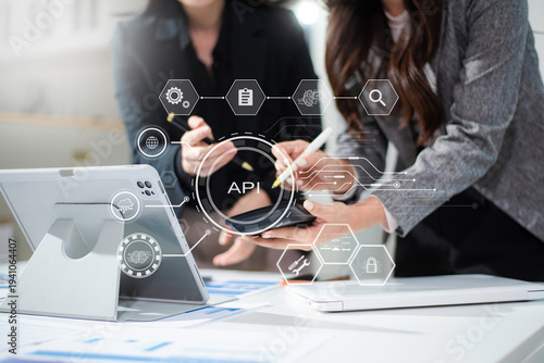 API Application Programming Interface, woman using laptop, tablet and smartphone with virtual screen API icon Software development tool