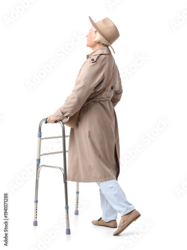 Senior woman in trench coat...