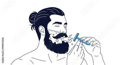 Handsome man with a beard and hair bun carefully shaving his face with a razor and white shaving cream foam in the morning.