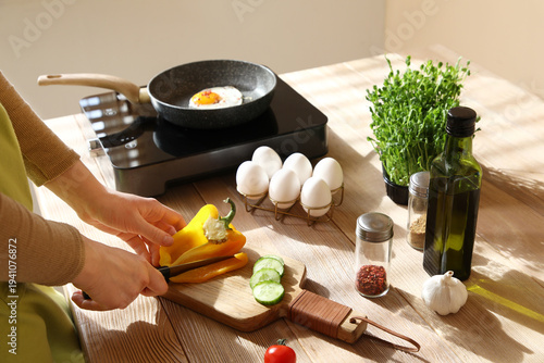 Woman cutting bell pepper w...