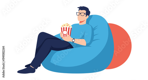 Casual man relaxing in a blue bean bag chair while holding a bucket of popcorn and watching a movie at home during his leisure time.