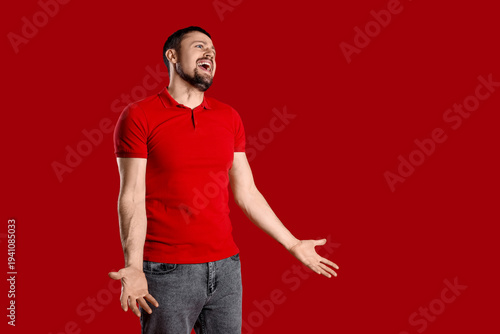 Screaming young man on red ...