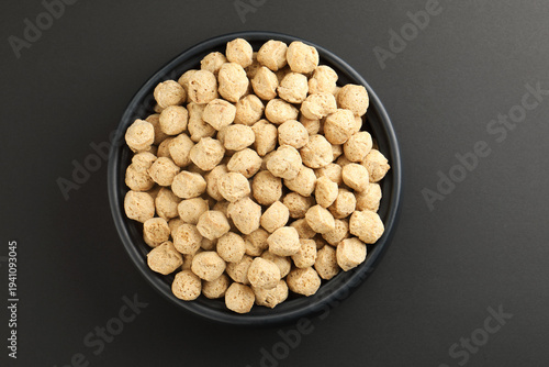 Raw soya chunks on  background. Healthy, nutritious soybean meat, chunks Vegan food concept.  known as soya wadi or meal maker in India 