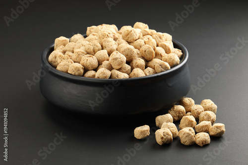 Raw soya chunks on  background. Healthy, nutritious soybean meat, chunks Vegan food concept.  known as soya wadi or meal maker in India 