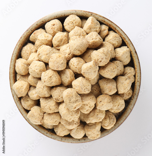 Raw soya chunks on  background. Healthy, nutritious soybean meat, chunks Vegan food concept.  known as soya wadi or meal maker in India 