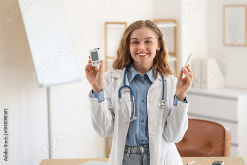 Female doctor with glucometer and lancet pen in office