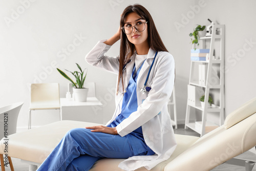 Thoughtful female doctor si...