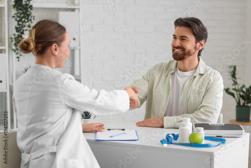 Young man with nutritionist...