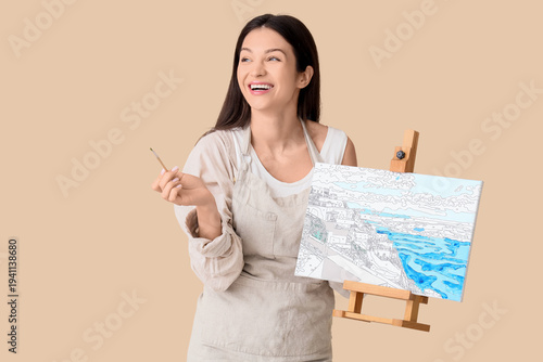 Female artist with painting...