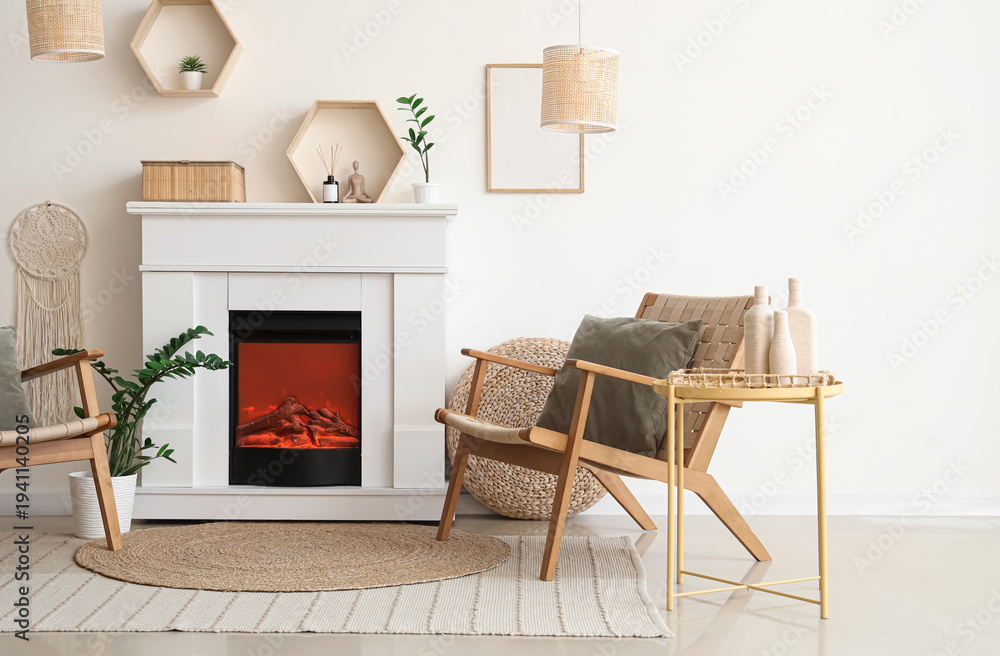 Naklejka premium Interior of light living room with fireplace and wicker armchair near white wall
