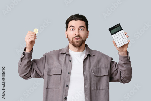 Surprised young man with bi...