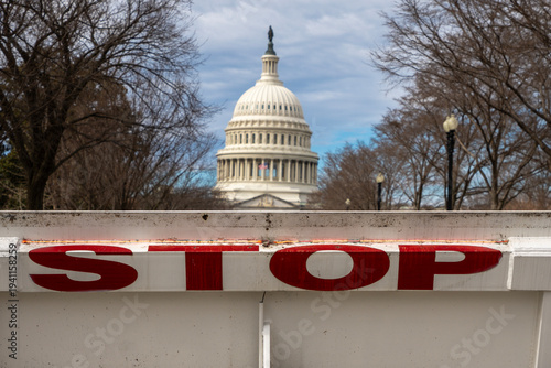 Stop barricade restricting entrance near Capitol. Government shutdown tension in Washington DC. Security barrier at Capitol Hill landmark. Political budget stalemate crisis.
