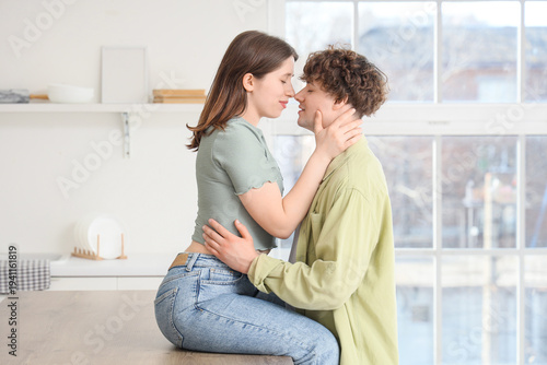 Young couple kissing in kit...