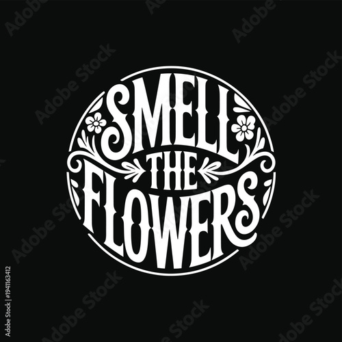 Circular design featuring the phrase smell the flowers in white lettering
