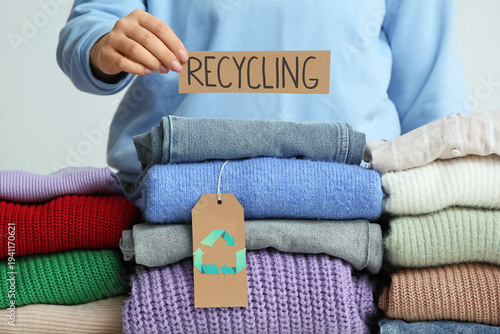 Woman holding RECYCLING sig...