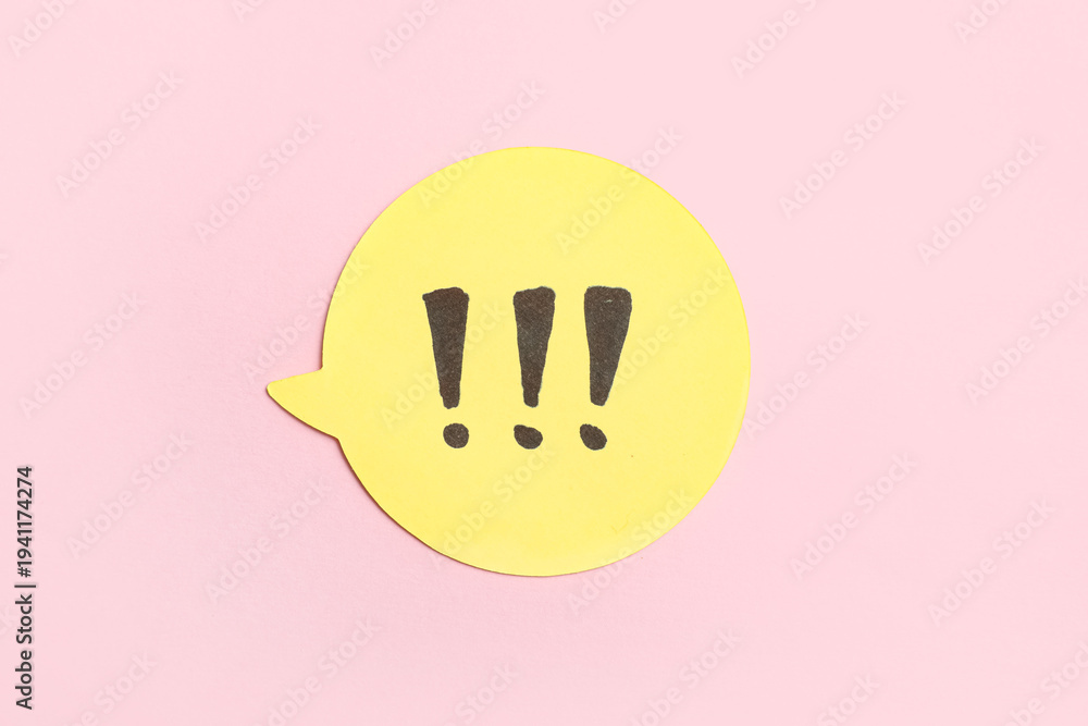 Fototapeta premium Yellow speech bubble with exclamation marks on pink background