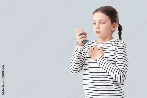 Cute girl with asthma inhal...