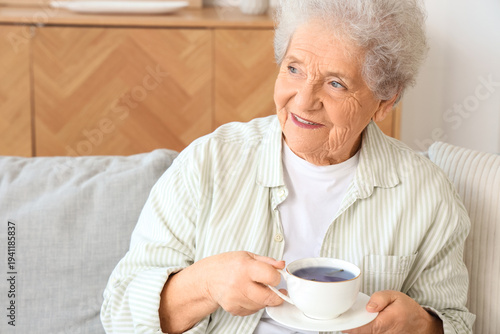 Senior woman with cup of bu...