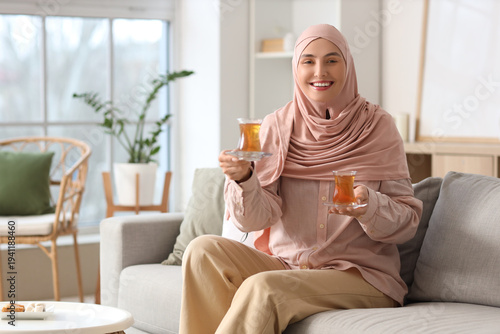 Young Muslim woman with gla...