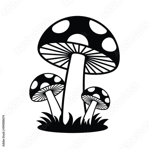 Black and white silhouette of three mushrooms with spotted caps growing in grass