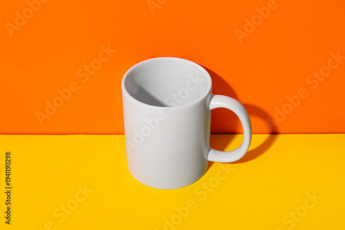 Stylish ceramic mug on yell...