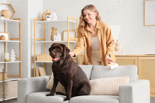 Young woman with lint rolle...
