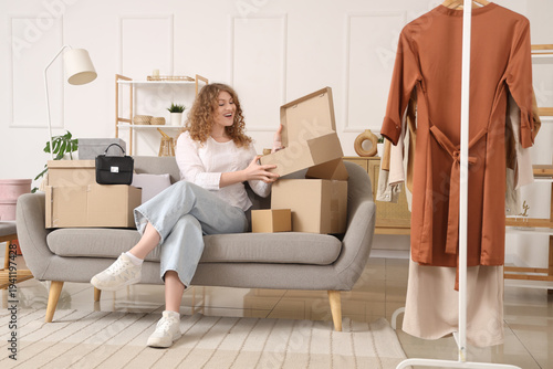 Happy young woman unpacking...
