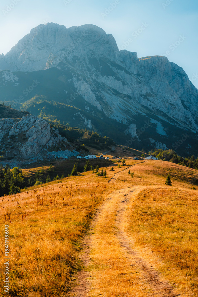 Fototapeta premium Sunset over the Maglic mountain massif seen from Prijevor saddle in Sutjeska National Park, the highest peak of Bosnia and Herzegovina at golden hour.