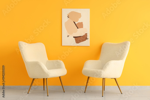 White armchairs and picture...