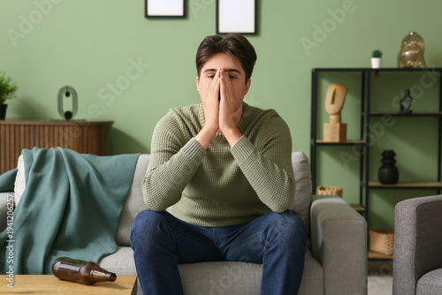 Depressed young man sitting...