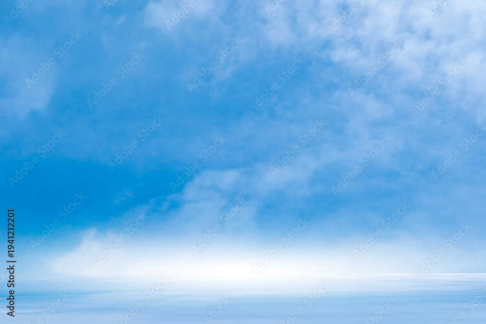 Obraz premium A bright, clear blue sky meets a glowing white horizon, suggesting a serene, open, and with sunlight of beautiful cloudy sky. landscape or abstract background