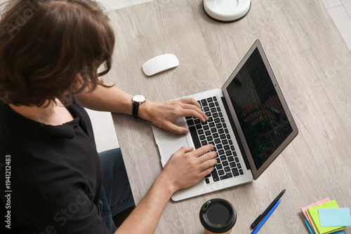 Male programmer working wit...