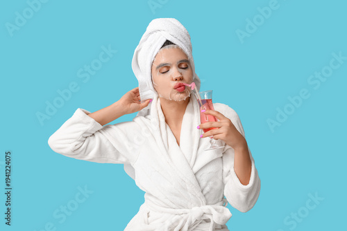 Young woman in bathrobe wit...