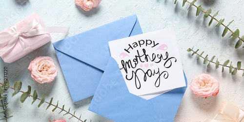 Greeting card with text HAPPY MOTHER'S DAY, envelopes and rose flowers on light grunge background