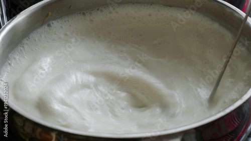 Slow Motion Stirring of Milk in Pot with Bubbles
