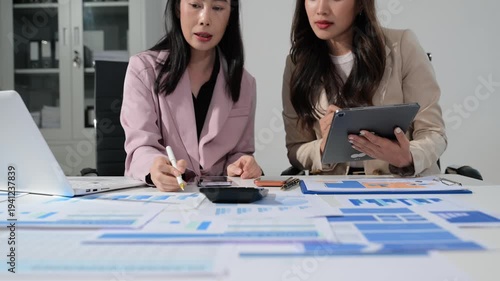 Business documents on office table with smart phone and calculator digital tablet and graph business with social network diagram