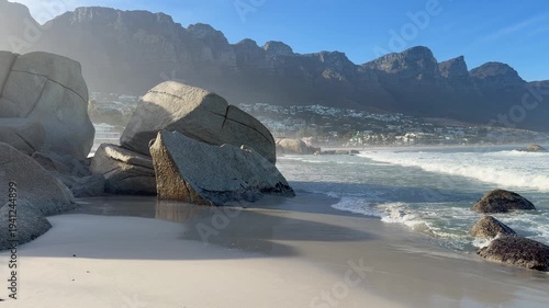 A stunning view of Camps Bay with the Table Mountain and 12 Apostles Mountain range in the background. Camps Bay, Cape Town, South Africa.