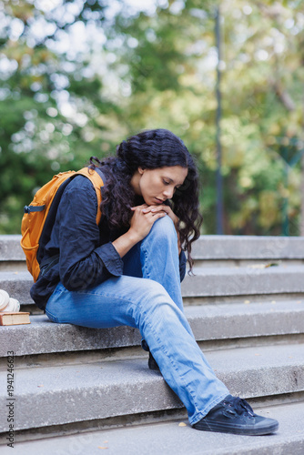 Valokuva Young student feeling sad and sitting alone on stairs