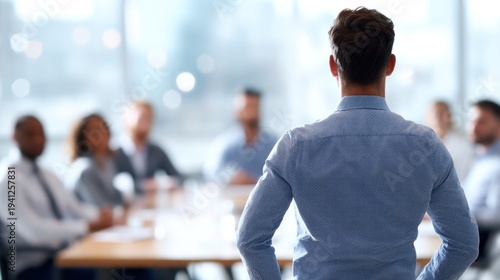 Man speaking to colleagues in meeting